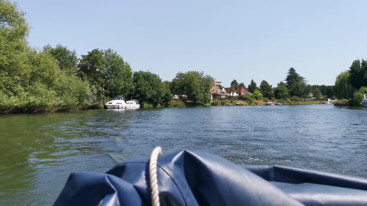 A backwards moving shot of a large boat moving through the river thames on a very sunny day in england, this video was shot on the sony A7siii dslr camera at 1080p