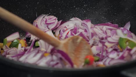 motion controlled slow motion shot of onions in a cooking pan