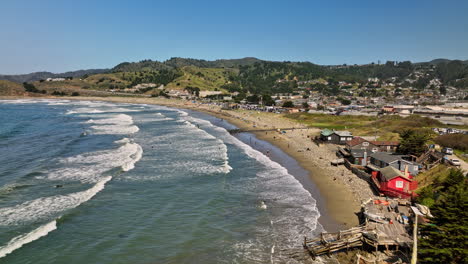 Pacifica-California-Aerial-v8-cinematic-low-level-flyover-crescent-shaped-linda-mar-state-beach-capturing-surfers-catching-the-waves-on-a-sunny-day-in-the-summer---Shot-with-Mavic-3-Cine---May-2022