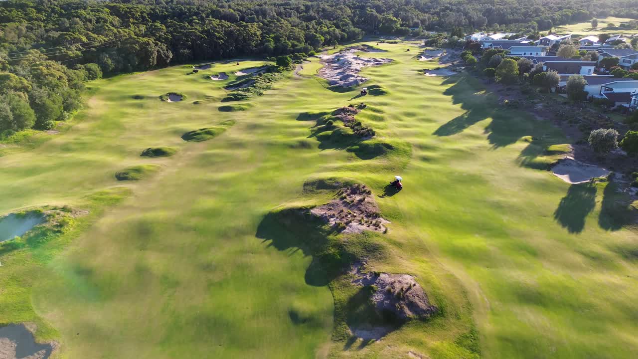 Drone aerial shot of Magenta Golf club with golf cart bunker on fairway early morning sport NSW Central Coast Australia 4K