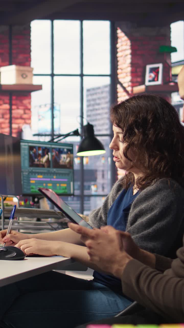 Vertical Video Team of analysts examining presentation charts and data on dashboard