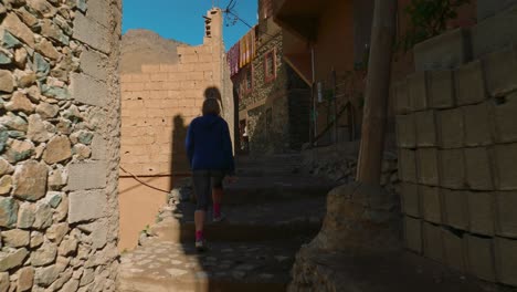 Blonde-tourist-girl-exploring-Moroccan-architecture-in-Imlil-mountain-valley