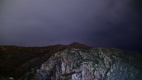 night cloudy timelapse over a rocky mountain in south africa