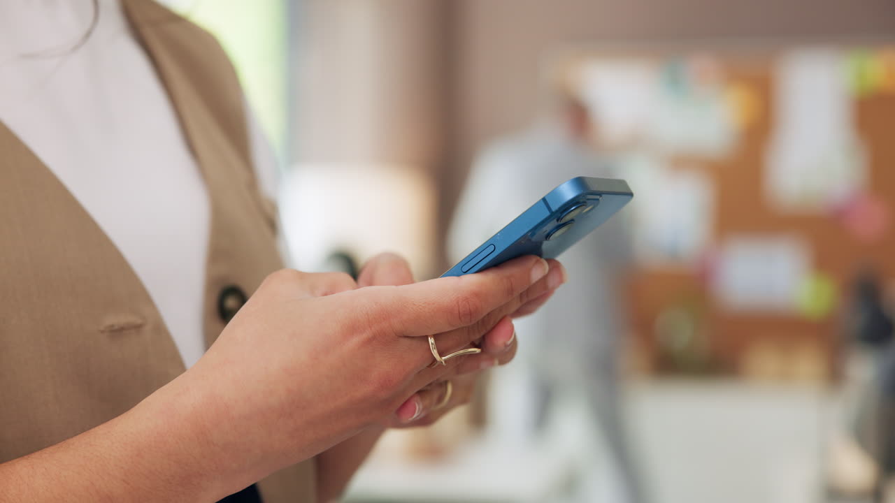 Close Up of Woman's Hands Typing on Blue Smartphone