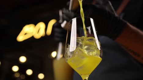 bartender pouring a cocktail