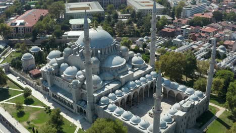 slowly circling around suleymaniye mosque in istanbul with green surroundings, epic aerial slide left