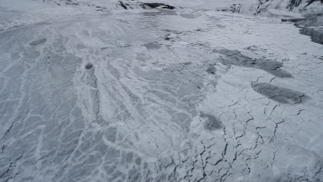 Slow-motion-POV-of-a-winter-ferry-boat-ride-in-Geirangerfjord-to-Geiranger,-Norway,-showcasing-ice-floating-from-mountains-in-the-fjord