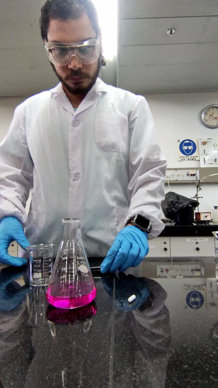 Chemist Writing on Glassware in Lab