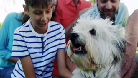 Multi-generation-family-playing-with-their-dog