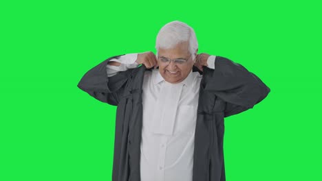 Happy-Indian-senior-lawyer-getting-ready-for-work-Green-screen