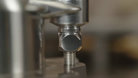 close-up of a metal bolt and nut being tightened