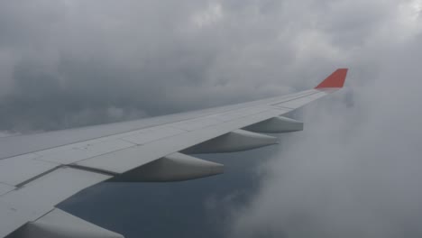 airplane wing view from the window during a cloudy flight