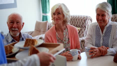 Active-Caucasian-senior-people-smiling-on-dining-table-at-nursing-home-4k