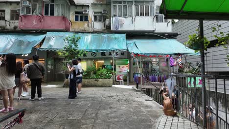 motionlapse of tourists taking photos by monster building in hong kong