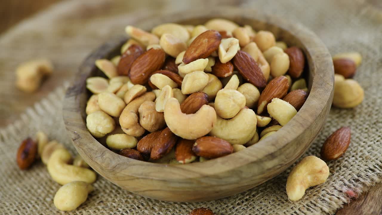 Portion of roasted nuts on a rotating plate (seamless loopable)