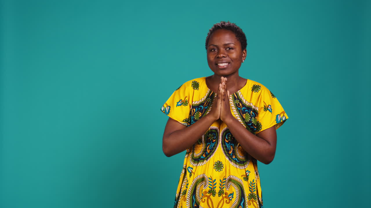 Confident optimistic woman holding hands in a prayer and talks to Jesus