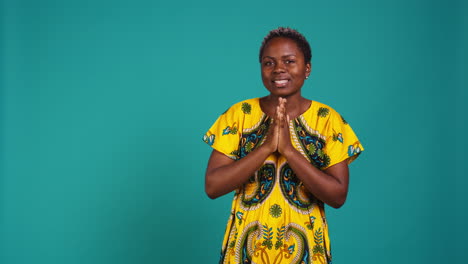 Confident-optimistic-woman-holding-hands-in-a-prayer-and-talks-to-Jesus