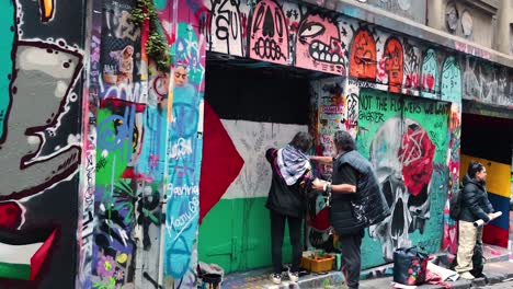 artists painting graffiti on a colorful wall