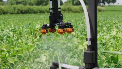 Close-up-of-new-agricultural-drone-spraying-system-on-green-crop-field