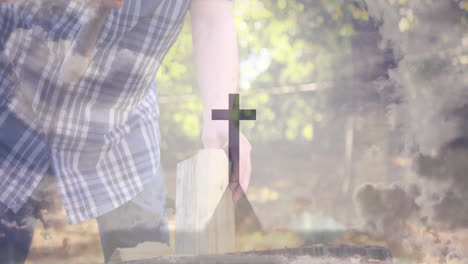 placing wooden block with cross symbol, person in outdoor setting with nature