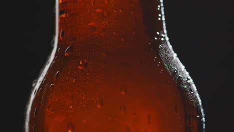 close up of condensation droplets on bottle of cold beer or soft drink