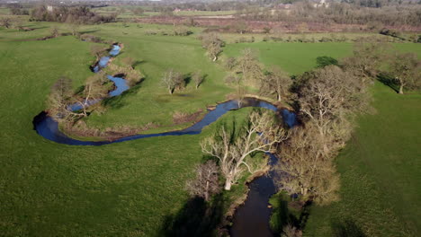 An-aerial-view-of-the-winding-River-Arrow-running-through-the-Warwickshire-countryside-in-England