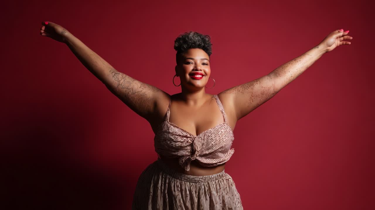 Celebrating Joy and Confidence: A Dancer Embracing Freedom and Self-Love with Outstretched Arms Against a Vibrant Red Background