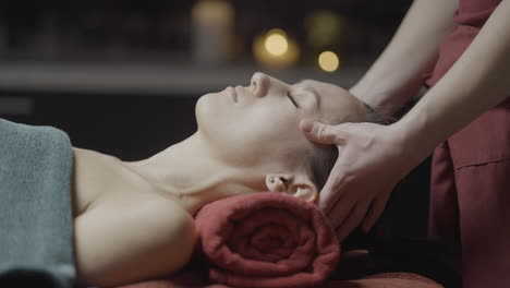 woman receiving a relaxing head massage at a spa