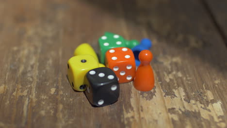 game dice and counters on wooden table