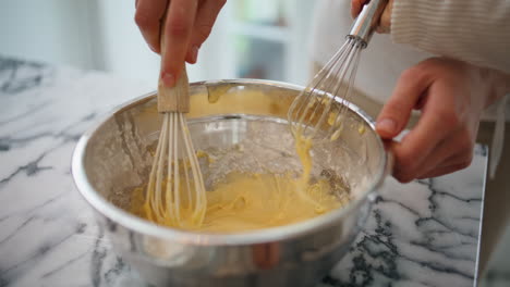 manos de bebé mujer mezclando ingredientes tazón en el interior de primer plano. cocina familiar desconocida