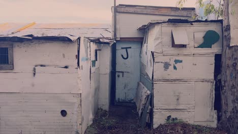 strolling past makeshift structures crafted from diverse materials like aluminum and sturdy paper, conjuring the essence of favela living