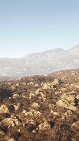 rocky mountain landscape with a clear sky and fog in the distance