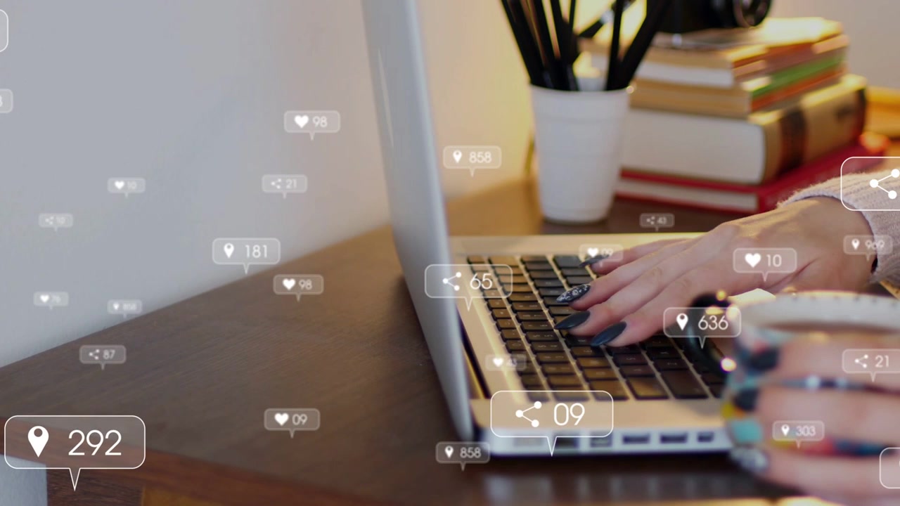 Man moving from trackpad to typing on laptop causing social media badges boosting engagement counts