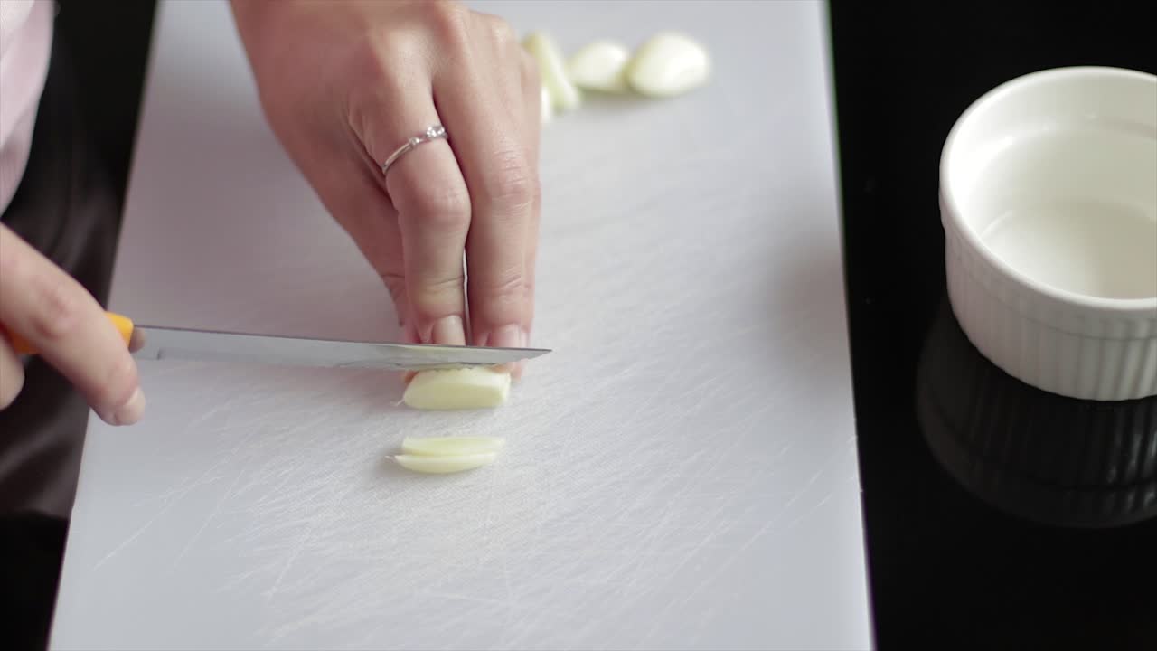 Slicing garlic into small pieces with a knife