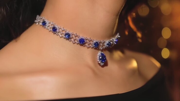 Close-up video of a woman's neck wearing a sapphire choker, elegant and luxurious style