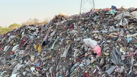 tracking shot of a pile of garbage at the dump yard, microplastic pollution