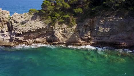 flying by the cliffside of the mediterranean sea