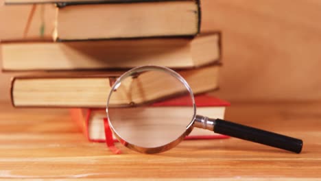 Magnifying-glass-with-a-book-on-desk