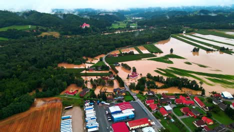 Horrific-Aerial-4K-Drone-footage-of-houses-in-Podravje,-Slovenia,-during-August-floods