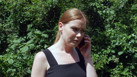 A-woman-receiving-bad-news-whilst-talking-on-the-phone-outside