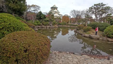 person walking in serene japanese garden setting