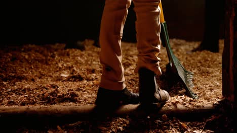 person cleaning stable with cleaning equipment 4k