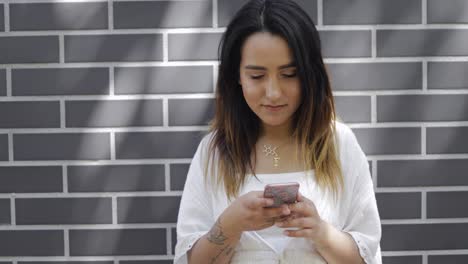 young woman reading a message on her cellphone