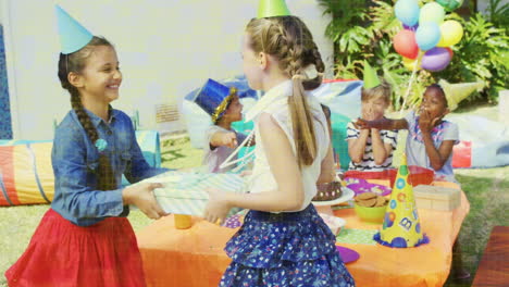 animation of shapes over diverse children with presents at birthday party