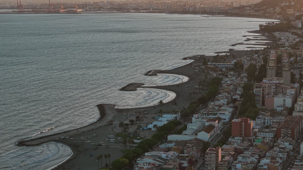 Aerial view of Málaga, Spain coastline with curved beaches and urban landscape along the Mediterranean Sea. Scenic seaside cityscape, travel and tourism destination, summer coastal vibes