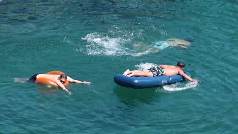 two people swimming and floating in the sea