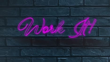 neon purple work it text against grey brick wall in background