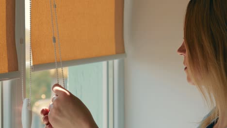 closing blinds, roller blinds, from direct sunlight. close up.