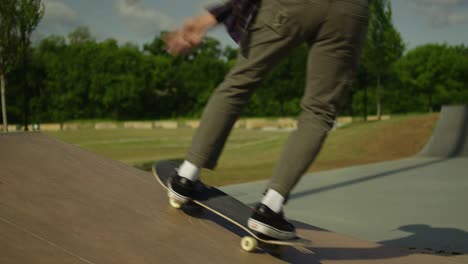 male skateboarder doing a backside kick flip at a skatepark