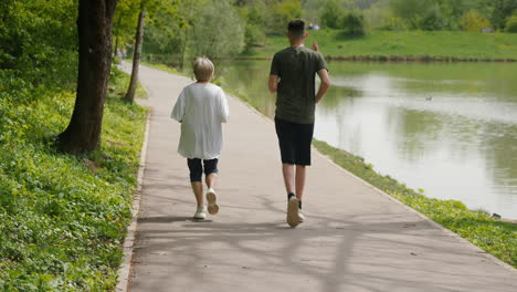 couple running in a park by a lake